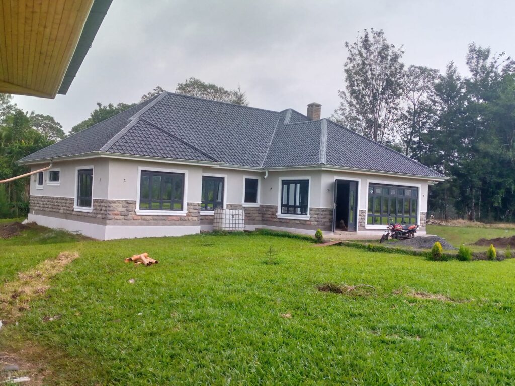 Residential house with grey tiled roof and landscaped lawn — Fusion John Construction